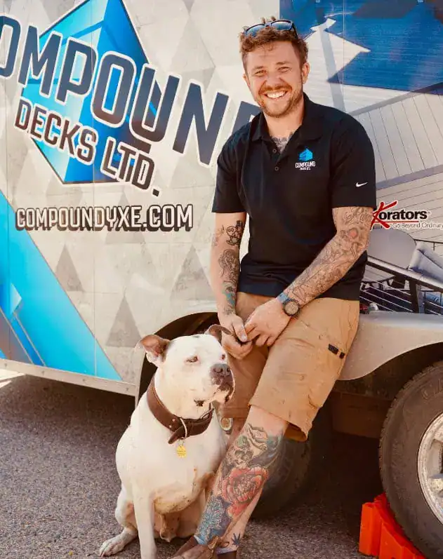 Man with dog in front of Compound Decks Ltd. truck in Regina SK.